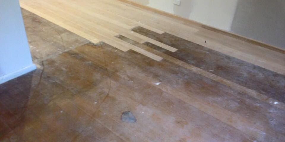 New timber boards patched into an old floor before sanding, Auckland