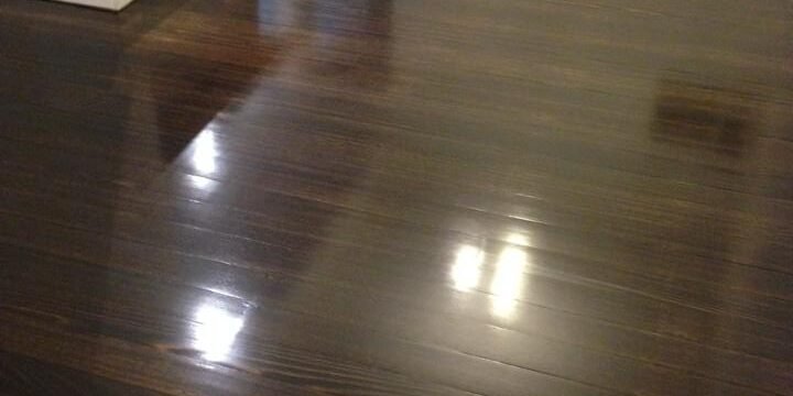 Dark-stained timber floor with a gloss finish in Auckland